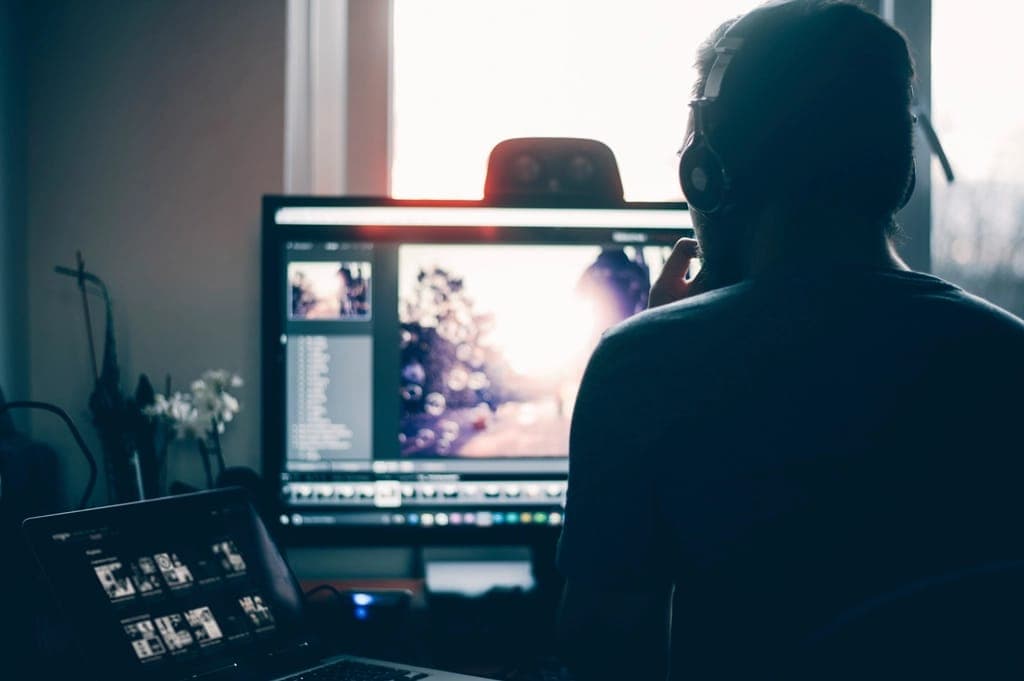 Designer working on a photo layout at a computer